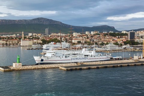 White blue and red Jadrolinija Oliver ferry boat docked at terminal in Port of Split in late