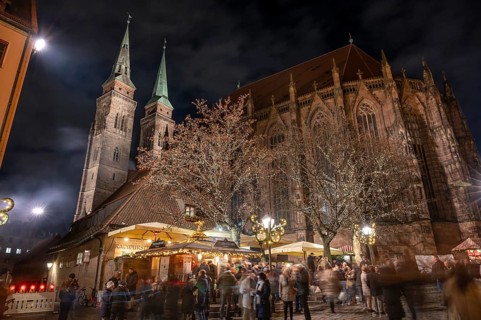 Christmas lighting at the Bratwursthäusle near St. Sebald, St. Sebald Church in the background,