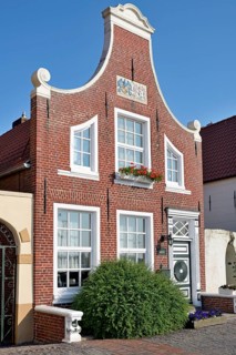 Historic building at the harbour of Greetsiel, blue sky, North Sea, Lower Saxony, Germany, Europe