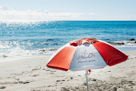 Lonely beach and parasol, Spiaggia di Biderosa, Riserva Biderosa nature reserve, Orosei, Nuoro
