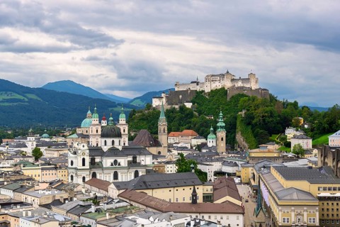 Traditional picture of the old town of Salzburg with the Hohensalzburg Fortress and dense cloud