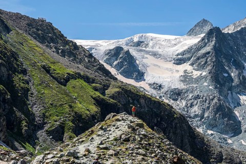 Hiking path up to mountain hut Cabane de Moiry, hiking tourist, Moiry glacier in the back, Valais,