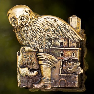 Door handle on the glass door of the town hall with motifs from the history of the city of
