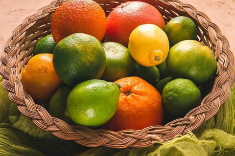 Assortment, citrus fruits, in a basket, close-up, top view, no people