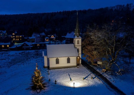 A Christmas tree stands in front of the smallest wooden church in Germany, Elend, 29 December 2020