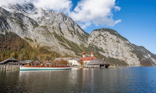 Königssee with Watzmann massif and pilgrimage church St. Bartholomä with tourist boat, autumnal