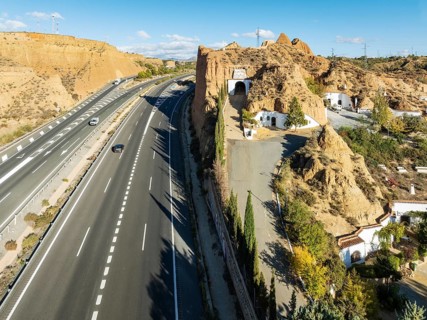 The A-92 highway next to the cave hotel Pedro Antonio de Alarcón in Gudadix. Aerial view. Drone