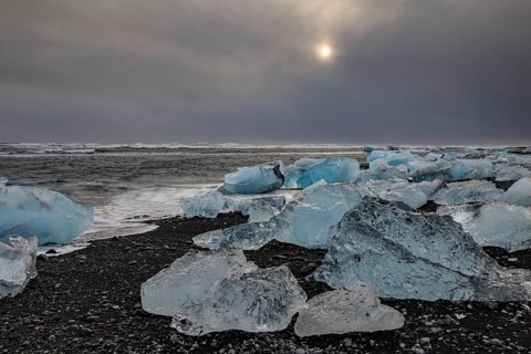 Ice floes on the beach, waves, sea, clouds, sunlight, winter, Diamond Beach, Breidamerkursandur,