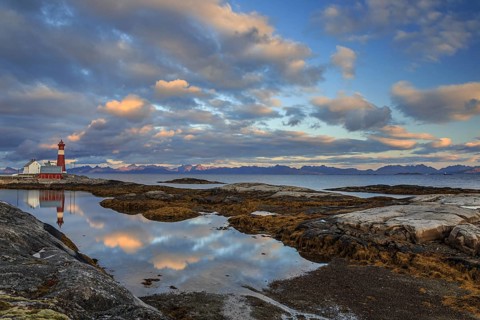 Lighthouse reflected in water, cloudy mood, mountains, coast, Tranoy, Ofoten, Norway, Europe