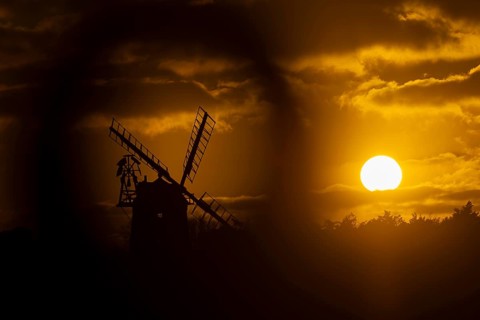 Windmill silhouette at sunset with a red sky and clouds, Cley-next-to-the-sea, Norfolk, England,