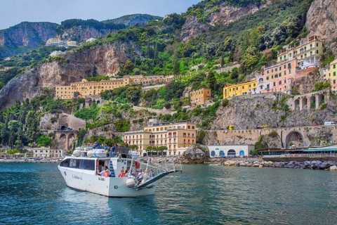 Waterfront of the village with excursion boat, Amalfi, Amalfi Coast, Amalfitana, Campania, Italy,