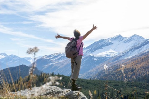 Woman Hiking and with Her Arms Outstretched and Enjoy Mountain Scape with Snow in San Bernardino,