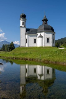 Seekirchl with reflection, Heiligkreuzkirche, Seefeld, Tyrol, Austria, Europe
