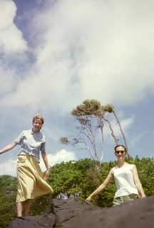 Two expatriate British women teachers standing on rock at the coast, Balandra, Trinidad, 1963