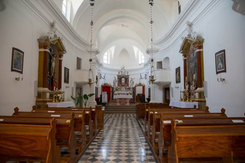 Bright church interior with wooden benches and magnificent altar, Benedictine monastery and Church