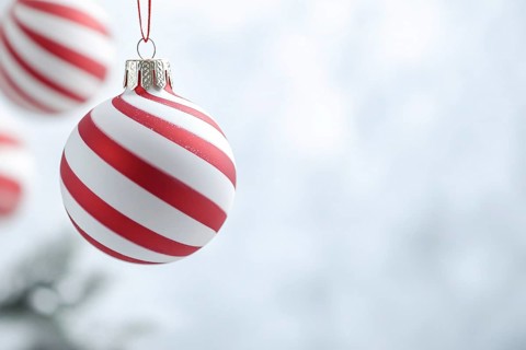Christmas bauble ornament with red and white stripes on tree with copy space. Generative AI, AI