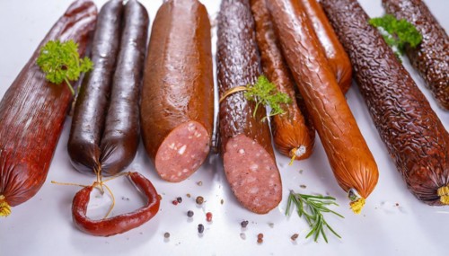 Food, meat products, various smoked sausages on a white surface AI generated, AI generated