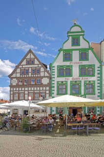 Historic restaurant Hofbräu am Dom with green tail gable, green, houses, street pub, people,