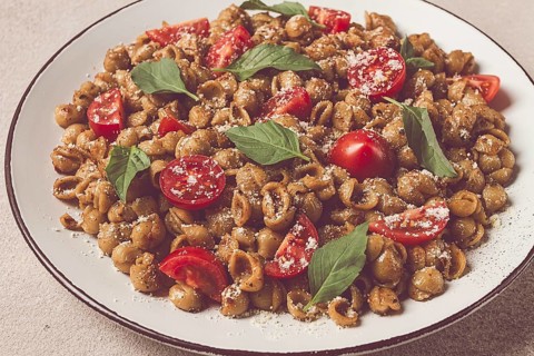 Tuscan pasta with smoked paprika and basil, parmesan cheese, Italian traditional cuisine