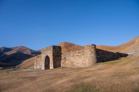 Historic caravanserai Tash Rabat from the 15th century, with yellow hills, Atbashy district in the