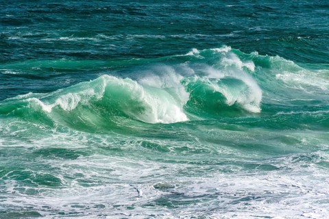 Waves breaking on Ipanema beach on a sunny summer day and the sea with greenish waters, Ipanema