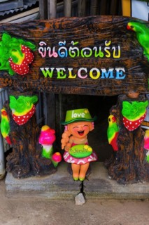 Welcome, sign in a hotel entrance, greeting, inviting, colourful, shrill, asian, friendly, hint,