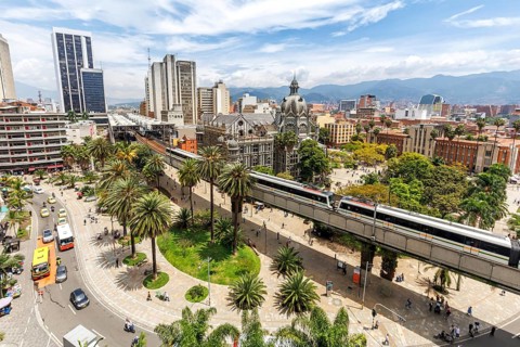Medellin skyline with a train of the Metro de Medellín at Plaza Botero in Medellin, Colombia, South