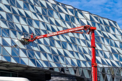 Building cleaners cleaning window panes, cleaning a facade, lorry working platform of the German