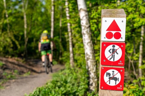 Signpost on the Brammentrail, mountain bike trail on the Schurenbach spoil tip, in Essen North