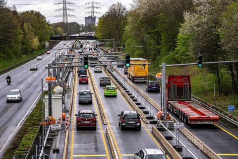 Weighing and barrier system on the A42 motorway, in front of the dilapidated motorway bridge over