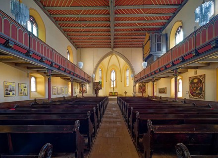 Late Gothic Protestant-Lutheran town church of St Peter with pulpit, altar, crucifix and baptismal