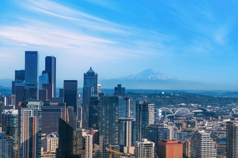 Panoramic Seattle financial district skyline in city downtown with Mount Rainier in the background