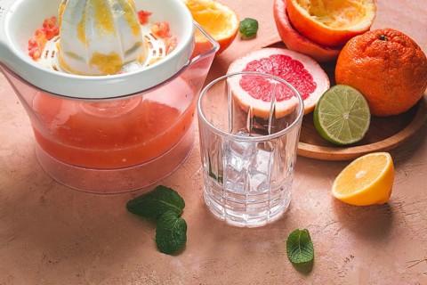 Citrus juicer, sliced fruit, glass with ice, close-up, no people, breakfast