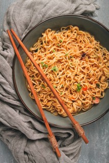 Instant noodles, in a bowl, on a gray table, top view, no people