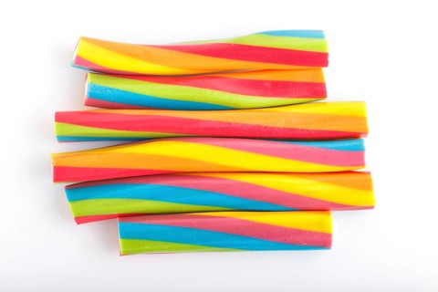 Rainbow chewing caramel sugar candies isolated on white background. top view