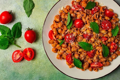 Tuscan pasta with smoked paprika and basil, parmesan cheese, Italian traditional cuisine