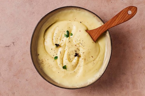 Mashed potatoes, with micro greenery and spices, homemade, on a beige table, no people, top view