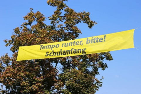 Tension tape over the road with a sign for school starters