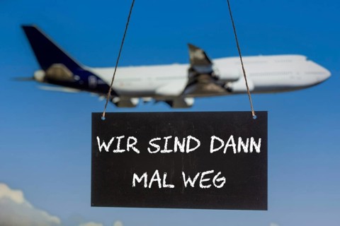 Symbolic image company holidays: Sign with the inscription WIR SIND DANN MAL WEG in front of an