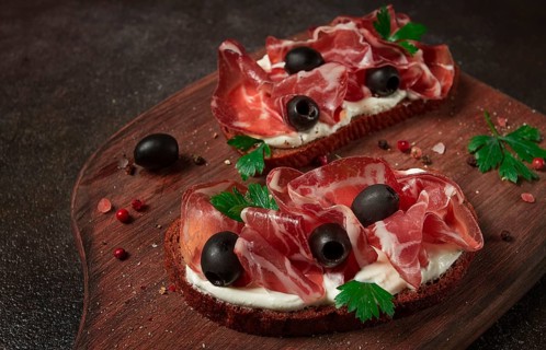 Sandwich with cream cheese, prosciutto with olives, breakfast