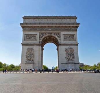 A central view of the Arc de Triomphe on a clear day with few people, Paris