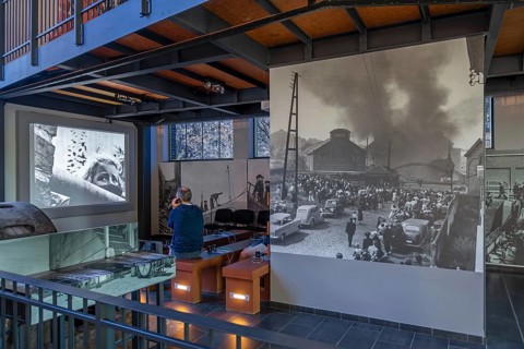 Visitors watching the August 8, 1956 Le Bois du Cazier coal mining disaster in the coal mine museum