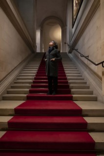 Woman Standing on a Red Carpet and Looking Up in Switzerland