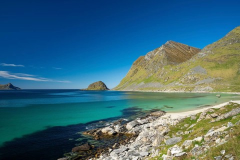 Landscape with sea at Haukland beach. On the right the mountains Veggen and Mannen. Shot during the