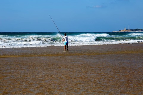 Man fishing from the beach at Conil de la Frontera, Cadiz province, Spain, Europe
