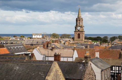 The Town Hall built 1754–60 set amongst rooftops, Berwick-upon-Tweed, Northumberland, England, UK