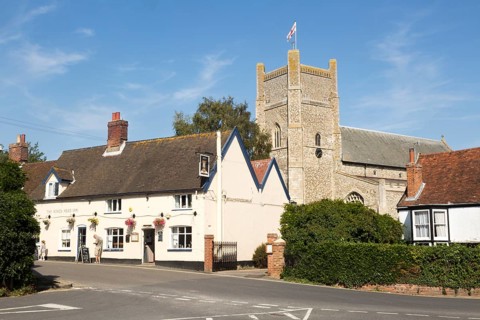 The Kings Head Inn and village church, Orford, Suffolk, England, UK