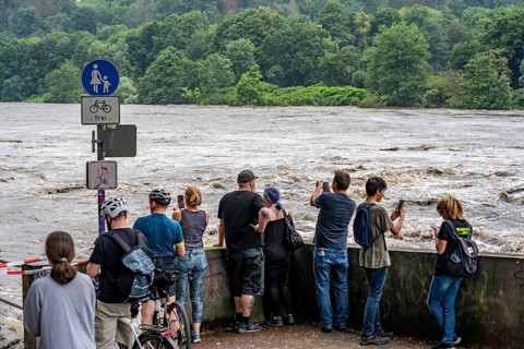 Weir of the Lake Baldeney in Essen, the masses of water roar through the open weirs, spectators,