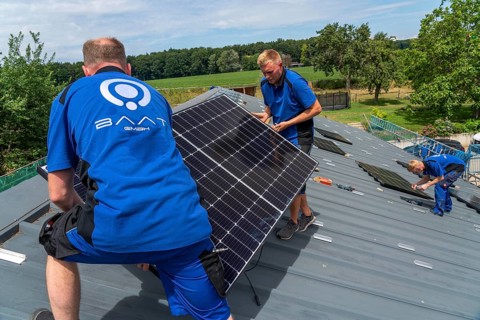 Installation of solar modules on the roof of a barn on a farm, over 240 photovoltaic modules are