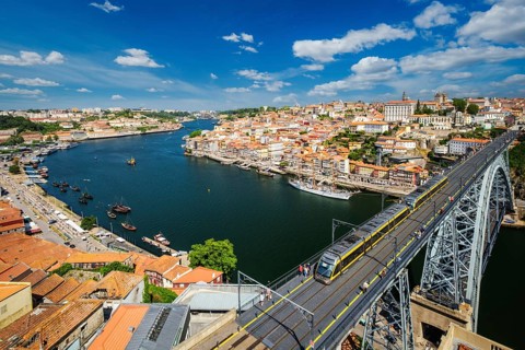 View of Porto city and Douro river and Dom Luis bridge I with metro tram from famous tourist